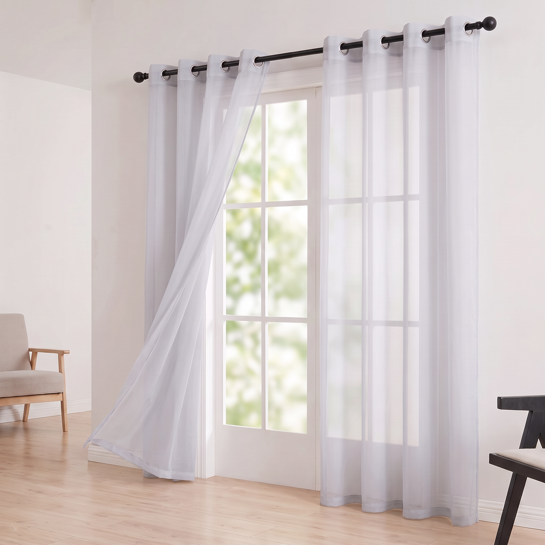 Sheer Voile Curtain Panel – Grommet Top in Silver – panel billowing beside a french door in a bright room