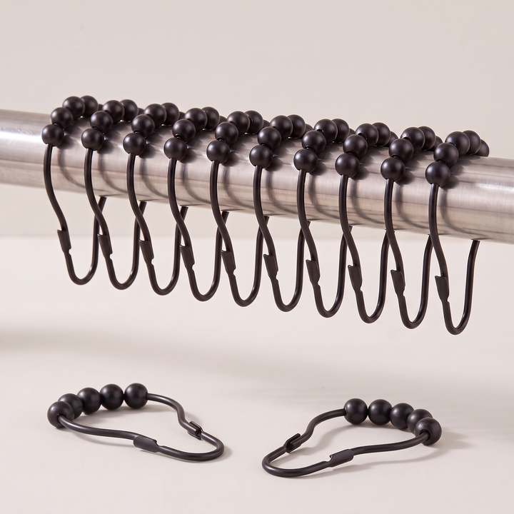 Shower Curtain Hooks – Set of 12, Roller Ball in Black – hanging from a metal rod with two loose hooks below