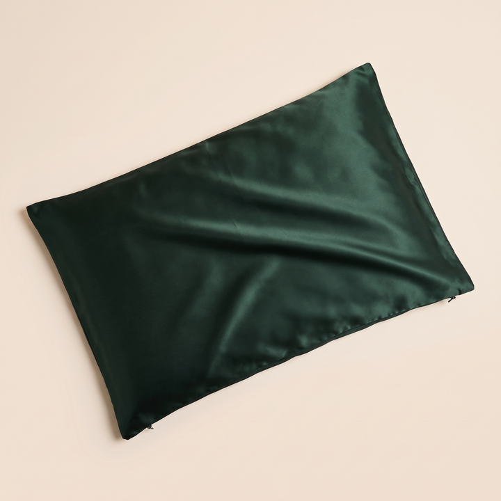 Silk Pillowcase – 19 Momme in Dark Green – top-down view with soft creases across the glossy surface