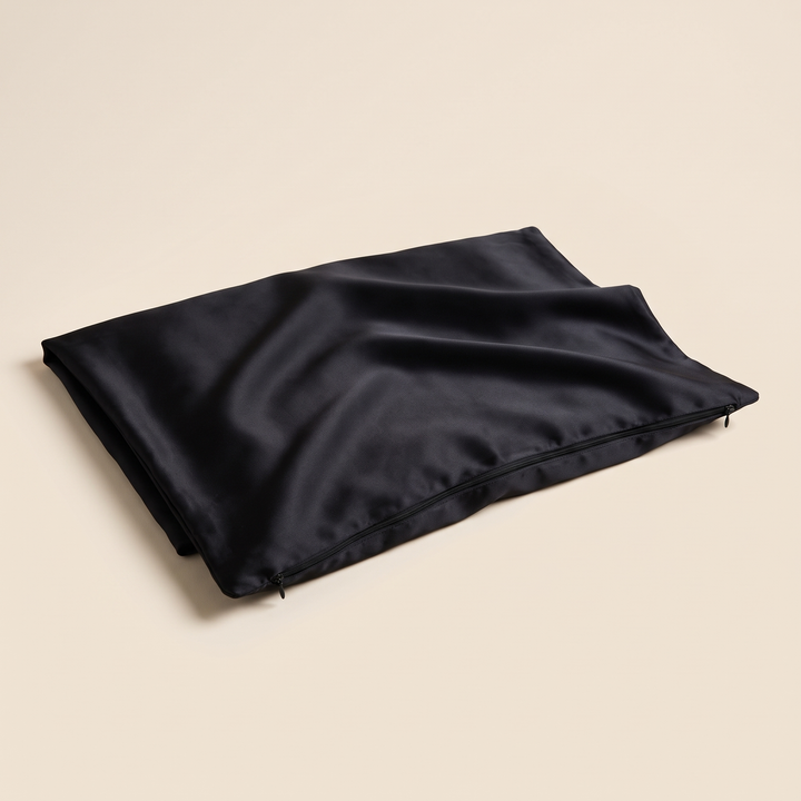 Silk Pillowcase – 19 Momme in Black – laid flat with visible zipper closure on a cream background
