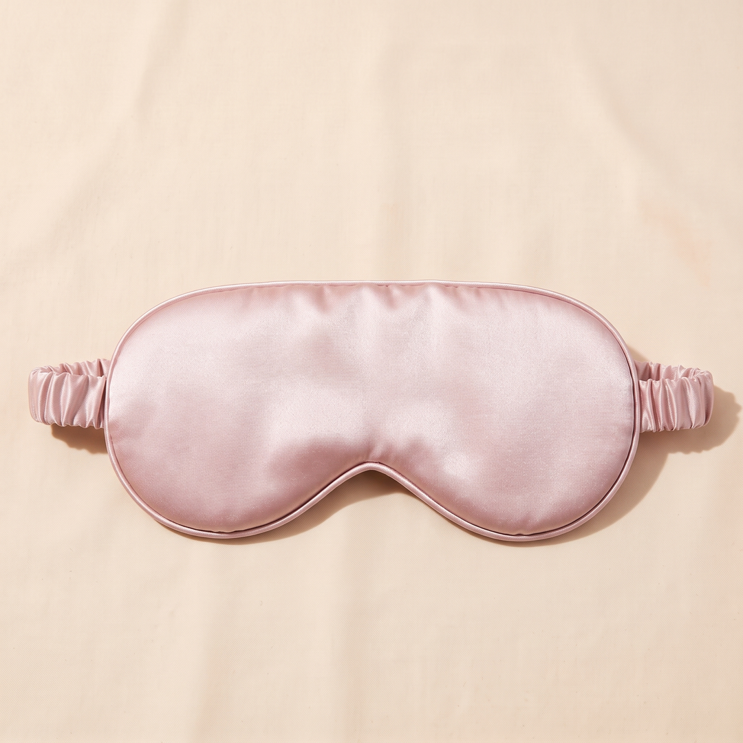 Silk Sleep Mask in Light Pink – straight-on with nose notch facing down, strap ends extending sideways