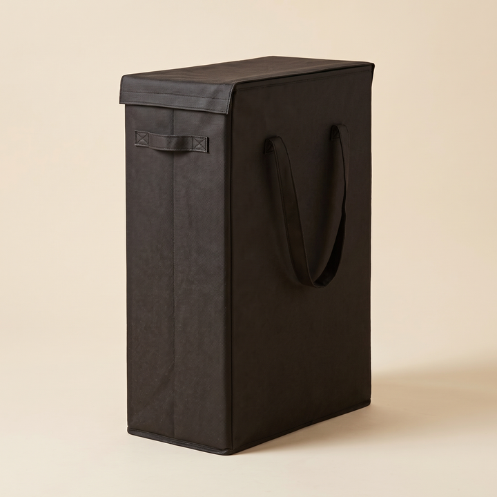 Slim Laundry Basket with Lid in Black – angled three-quarter view against a plain beige backdrop