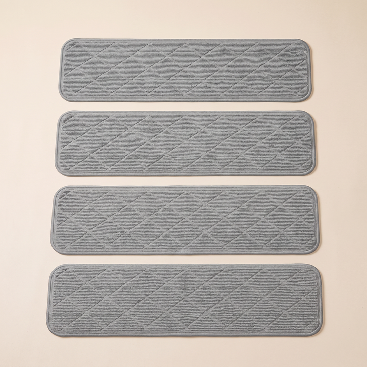 Carpet Stair Treads – Non-Slip, Self-Adhesive in Gray – overhead view of four spaced treads with ribbed diamond texture