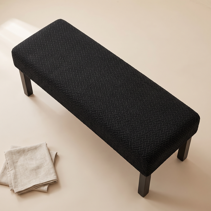Stretch Bench Seat Cover – Jacquard in Black – with folded linen napkins resting on the floor nearby