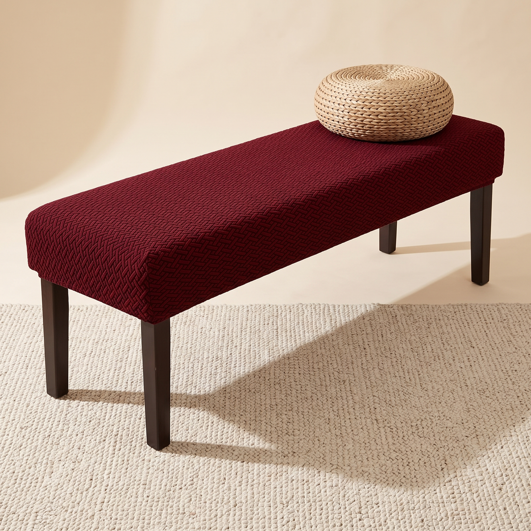 Stretch Bench Seat Cover – Jacquard in Burgundy – topped with a woven pouf on a cream rug