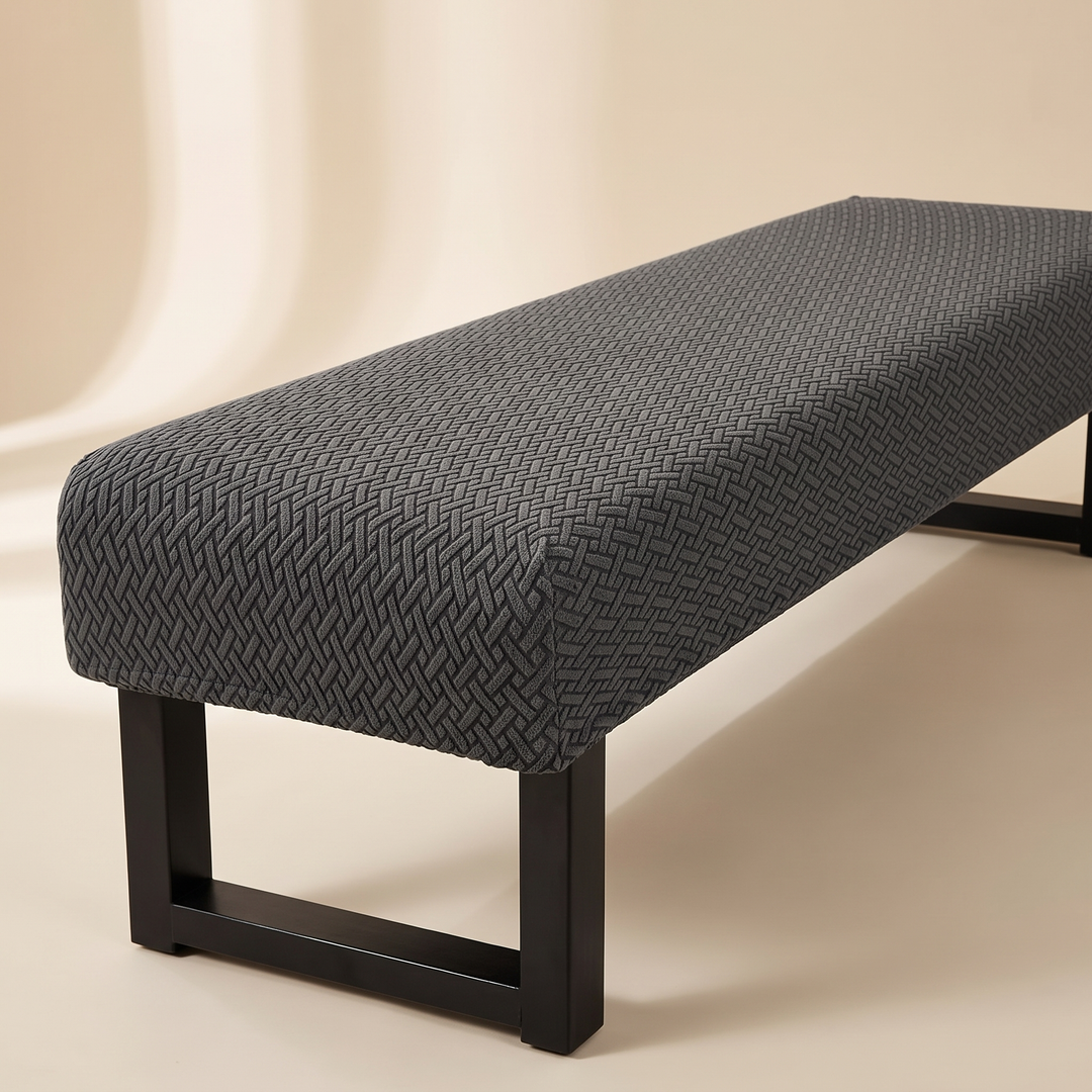Stretch Bench Seat Cover – Jacquard in Dark Gray – on a cream floor beside a softly lit curved wall