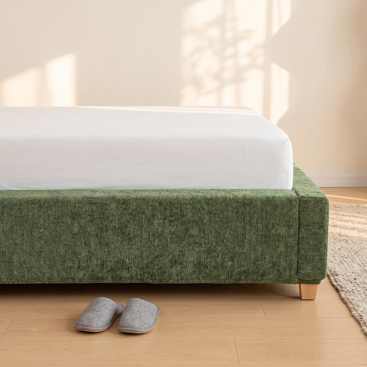 Stretch Box Spring Cover in Forest Green – end of bed with grey slippers and woven rug