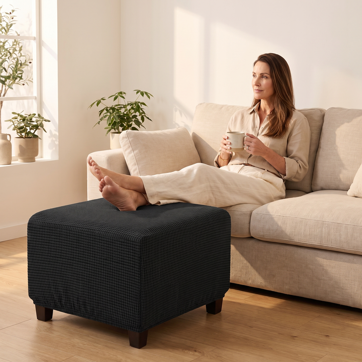 Stretch Ottoman Cover in Black – woman resting bare feet on top while holding a mug