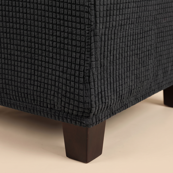 Stretch Ottoman Cover in Black – close-up of the textured grid fabric at the corner seam