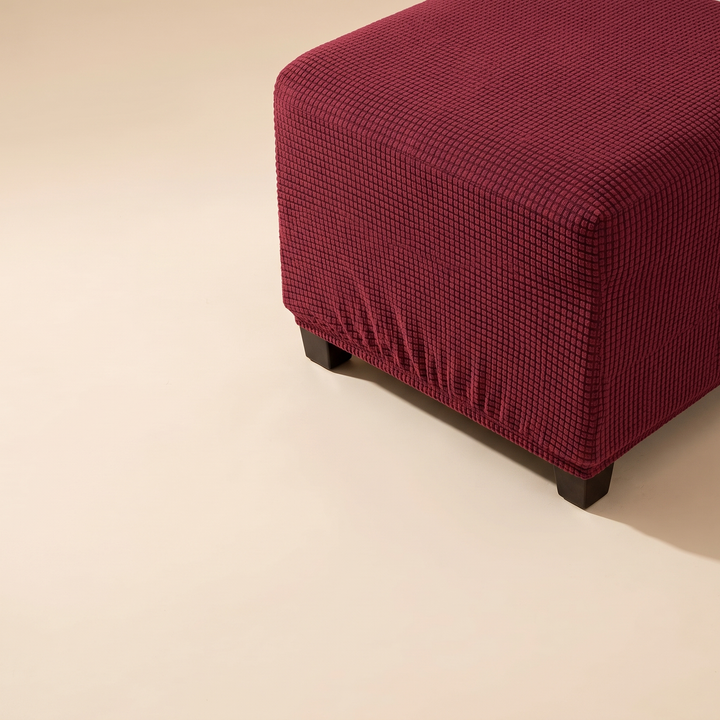 Stretch Ottoman Cover in Burgundy – upper right corner with two legs and shadow on floor