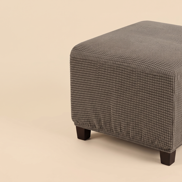Stretch Ottoman Cover in Chocolate Brown – cropped at right frame edge with empty space beside it