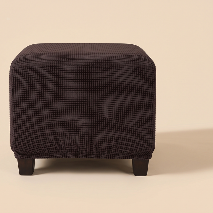 Stretch Ottoman Cover in Dark Brown – slightly elevated front view with soft shadow falling to the right
