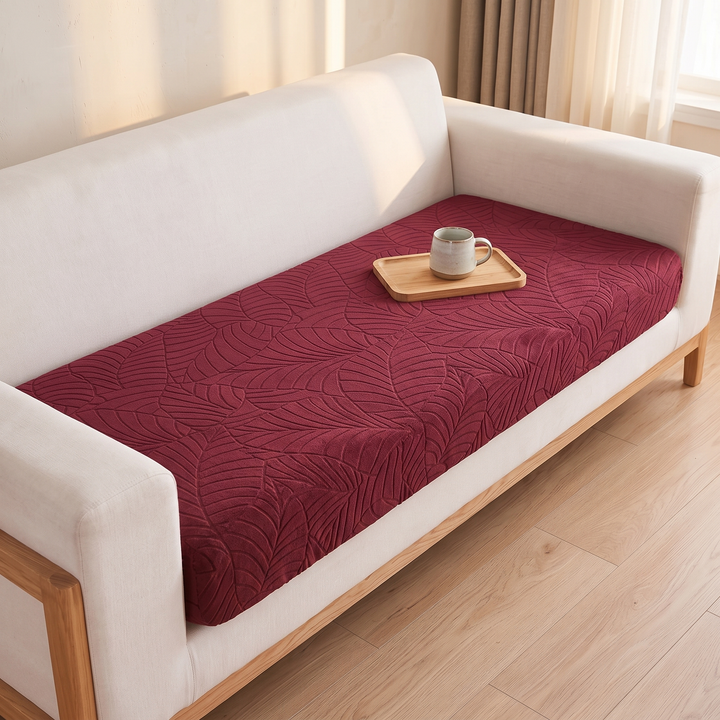 Stretch Couch Cushion Cover – Leaf Jacquard in Burgundy – lengthwise view from one armrest across the whole seat