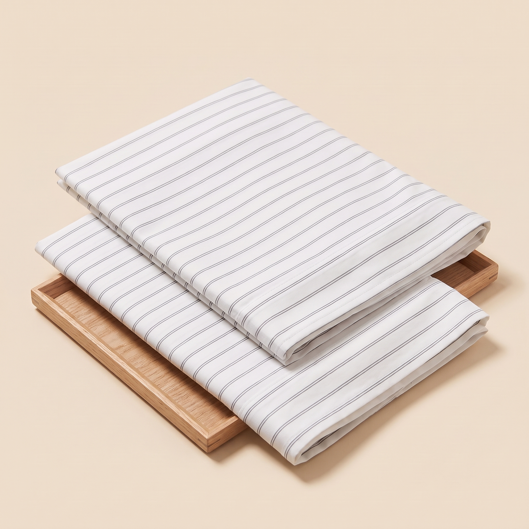Striped Cotton Pillowcases – Set of 2 in Gray Pinstripe – folded pair resting on a shallow wooden tray
