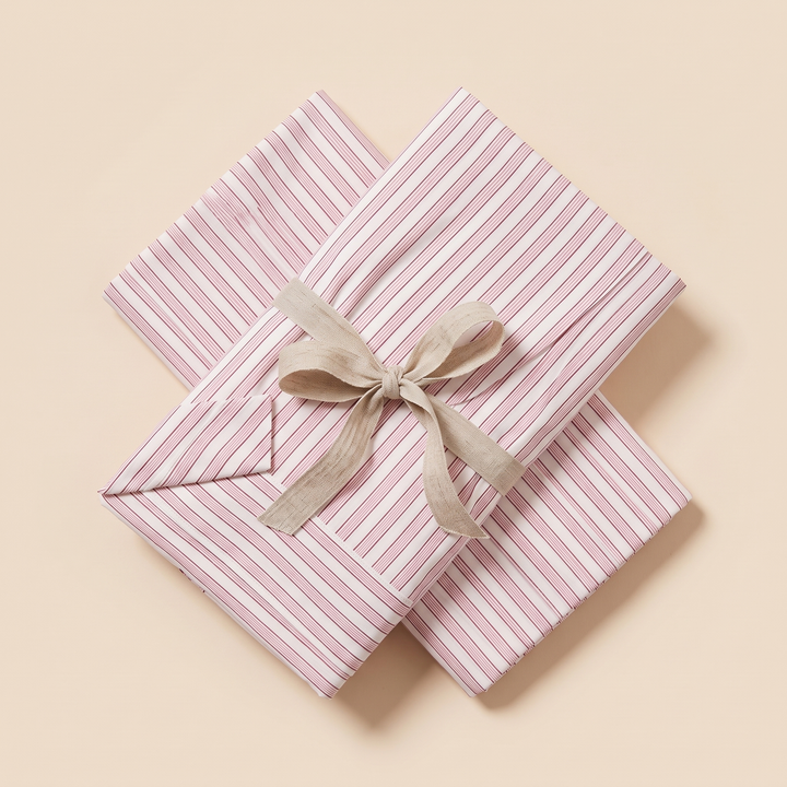 Striped Cotton Pillowcases – Set of 2 in Pink Pinstripe – two folded pillowcases crossed and tied with a linen ribbon bow