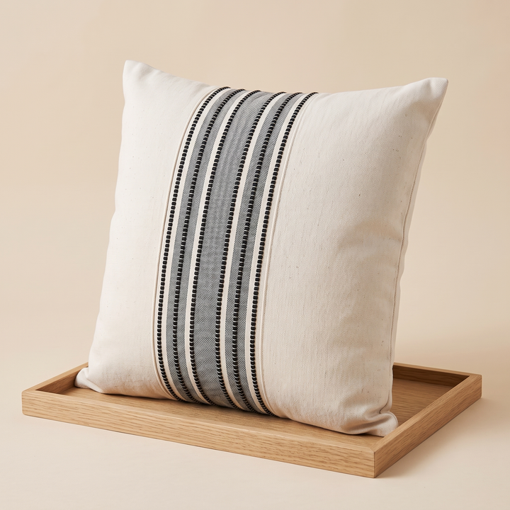 Striped Throw Pillow Cover in Black Stripe – propped on a shallow light wood tray, seen from an angle