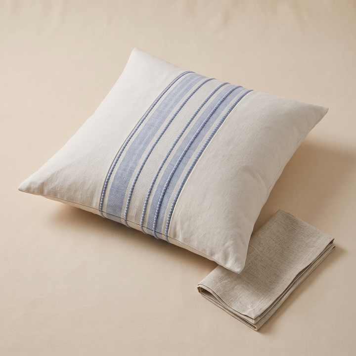 Striped Throw Pillow Cover in Light Blue Stripe – lying flat next to a folded linen napkin