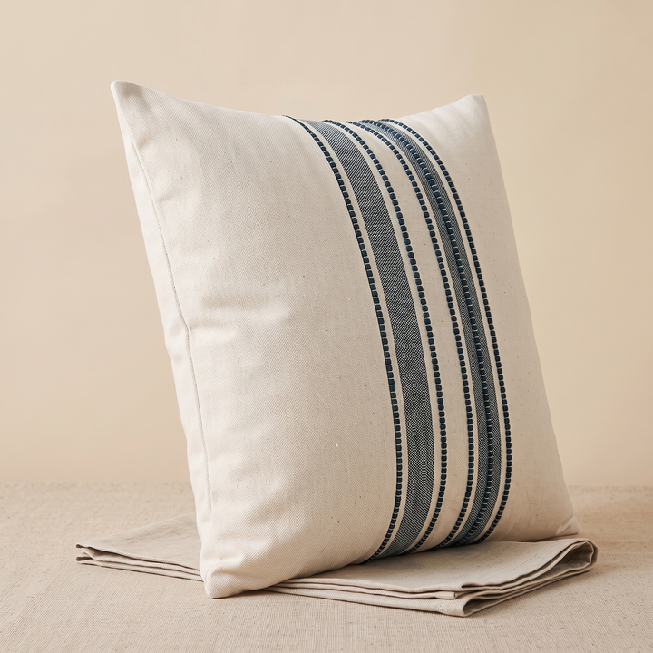 Striped Throw Pillow Cover in Navy Stripe – resting upright on top of a folded linen cloth