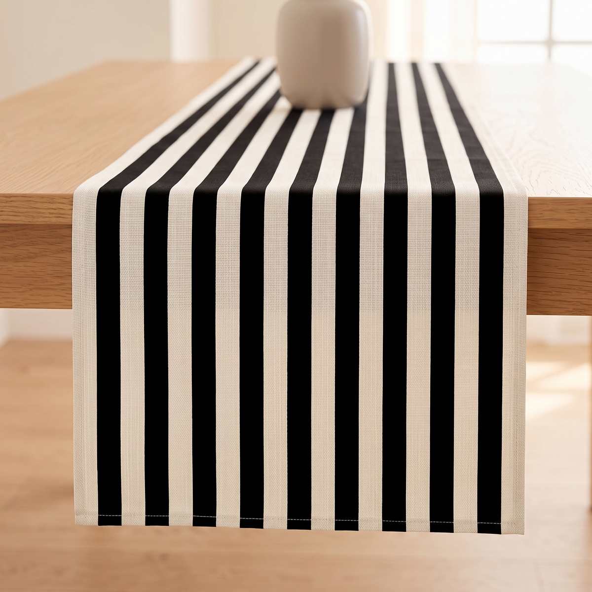 Striped Table Runner in Black Stripe – front view of hemmed end hanging over table edge