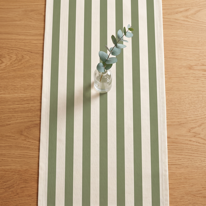 Striped Table Runner in Sage Green Stripe – overhead view with eucalyptus sprig in glass vase