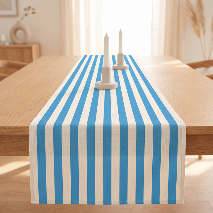 Striped Table Runner in Sky Blue Stripe – with two taper candles on dining table by sunlit window