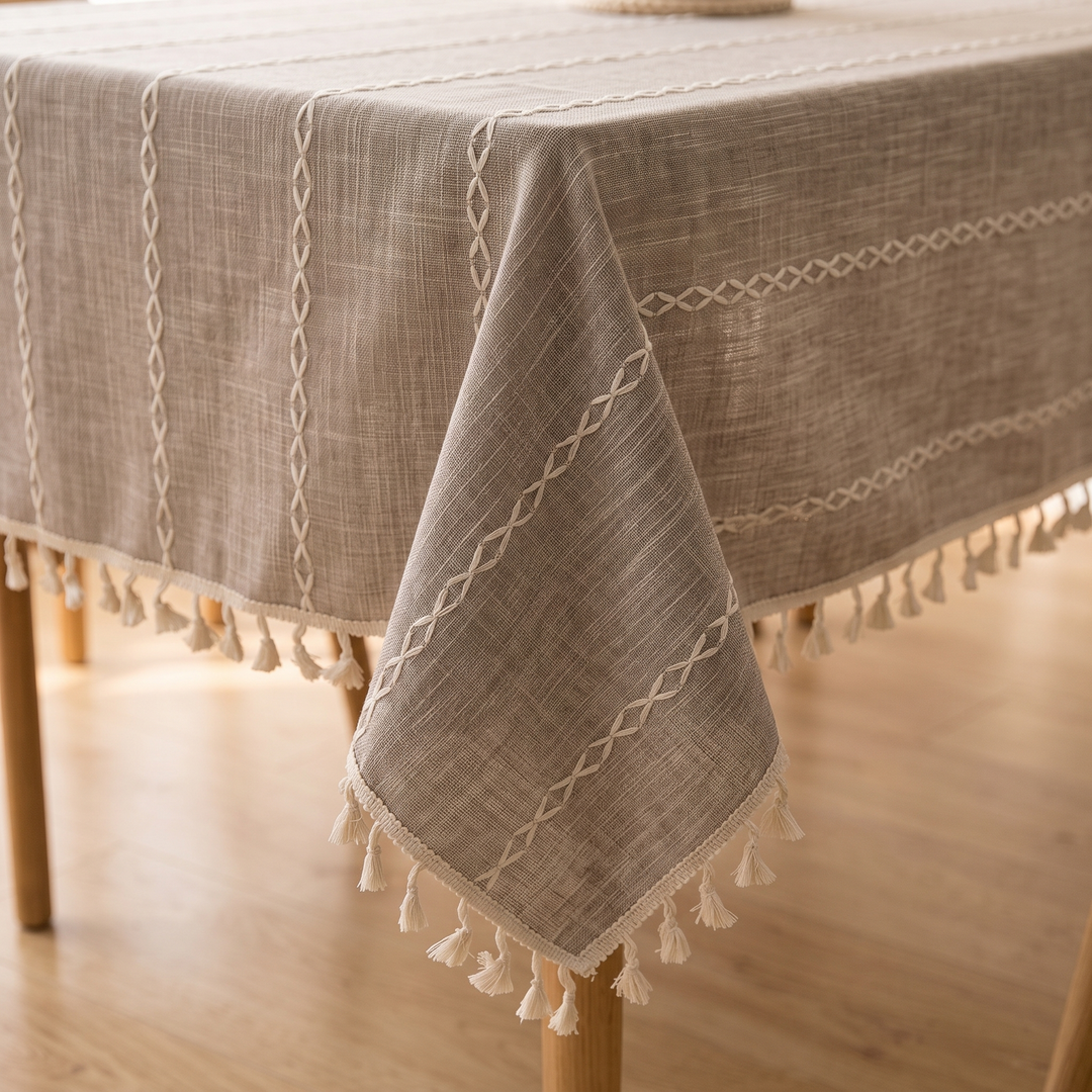 Striped Tassel Tablecloth – Linen Look in Taupe Stripe – corner draped over a wooden table with tassels hanging