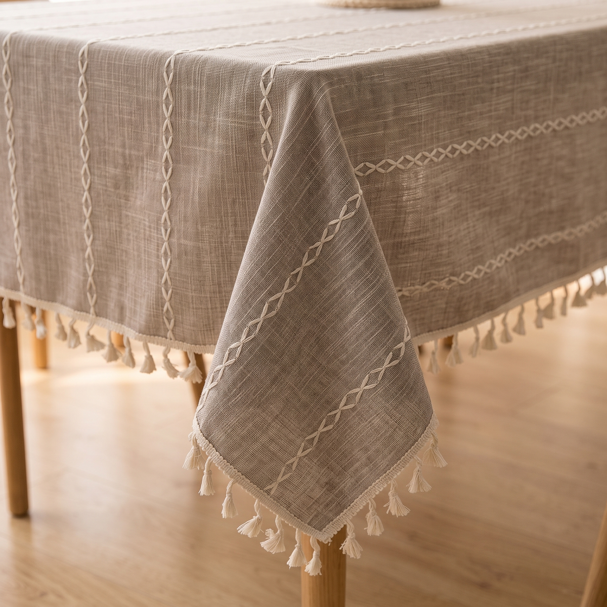 Striped Tassel Tablecloth – Linen Look in Taupe Stripe – corner draped over a wooden table with tassels hanging