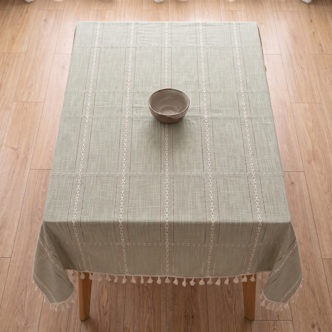 Striped Tassel Tablecloth – Linen Look in Sage Grid – overhead view on a rectangular table with a single ceramic bowl