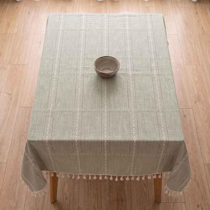 Striped Tassel Tablecloth – Linen Look in Sage Grid – overhead view on a rectangular table with a single ceramic bowl