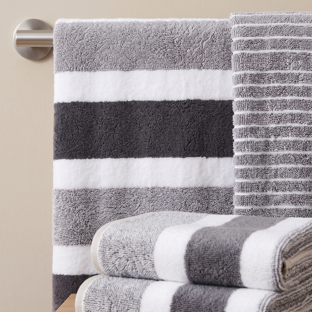 Striped Bath Towel Set – 8 Piece in Gray Stripe – hanging on a wall-mounted metal towel bar beside folded towels