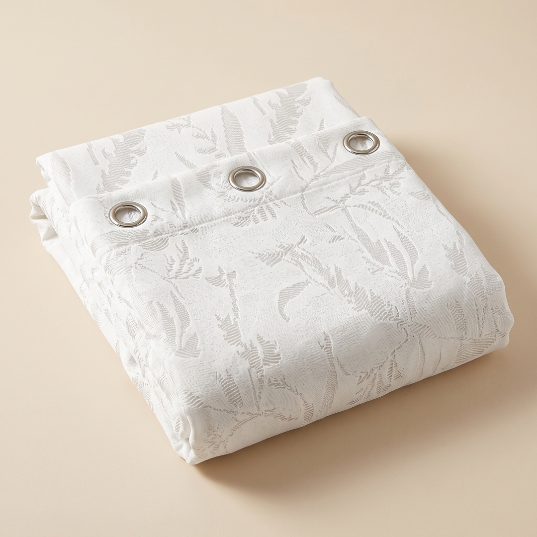 Textured Shower Curtain – Botanical Jacquard in White – folded neatly into a square stack on a beige surface