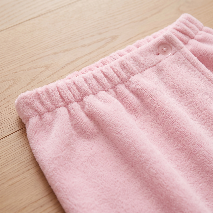 Towel Wrap – Bath &amp; Spa in Pink – close-up of fleece pile on a light wood surface