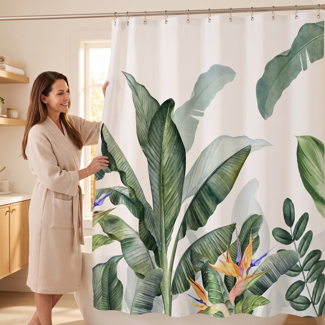 Tropical Shower Curtain – Monstera &amp; Palm Leaves in White – Banana Leaves – woman in a robe touching the curtain in a sunlit bathroom