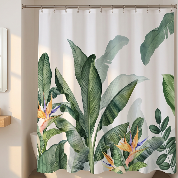 Tropical Shower Curtain – Monstera &amp; Palm Leaves in White – Banana Leaves – hanging from a rod above a white bathtub in a bright bathroom