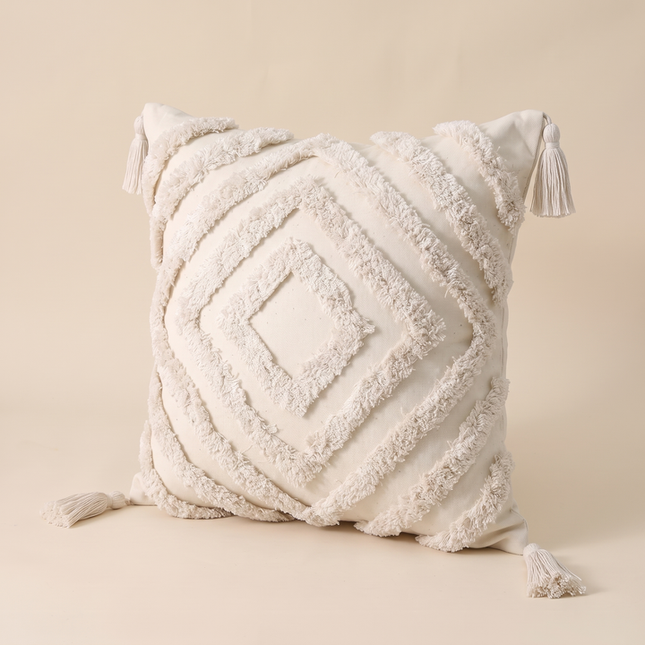 Boho Tufted Pillow Cover with Tassels in Cream – Diamond – angled three-quarter view showing all four corner tassels