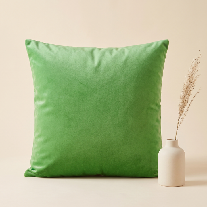 Velvet Pillow Cover in Grass Green – beside a cream ceramic vase with a dried grass stem