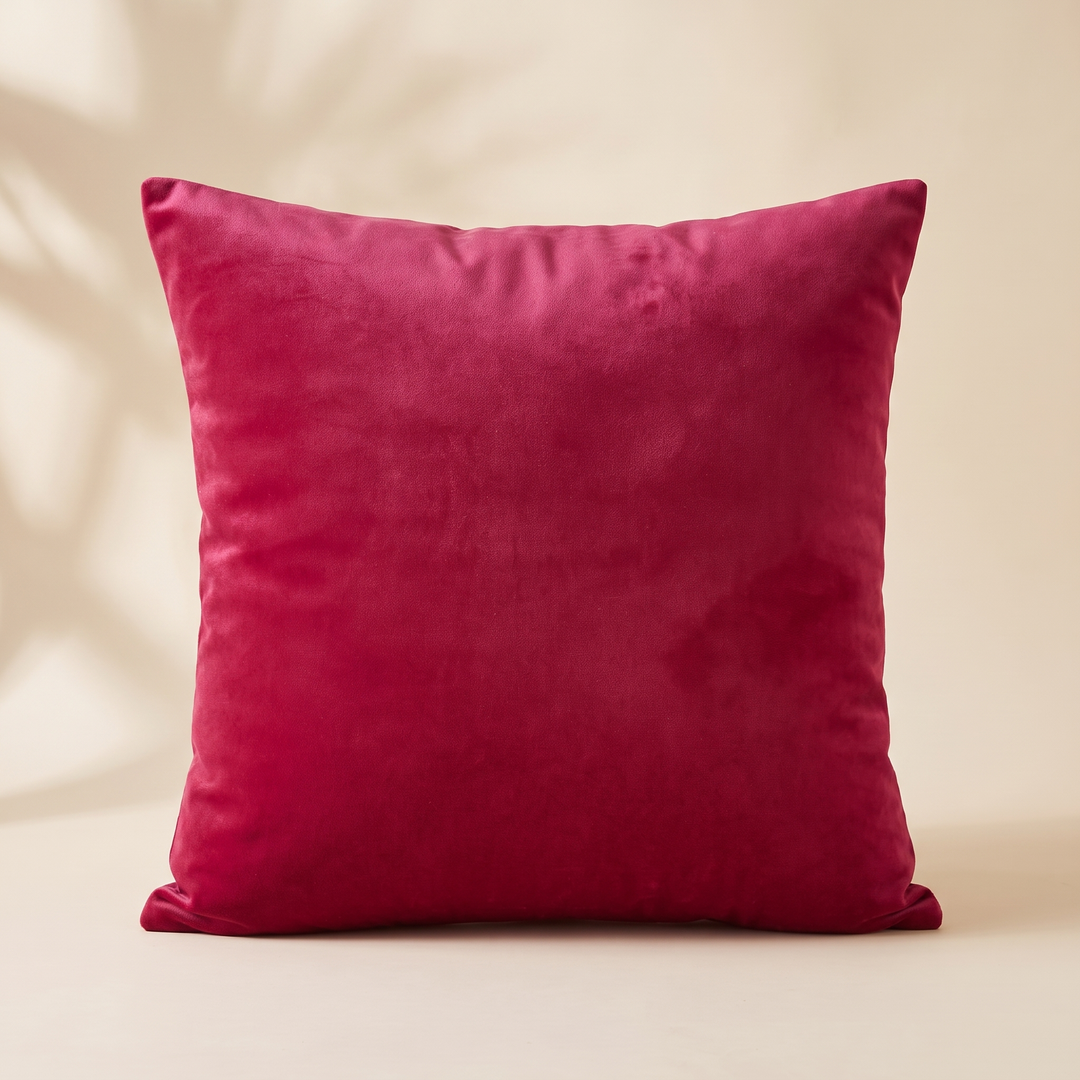Velvet Pillow Cover in Hot Pink – upright with soft leaf shadows falling across the wall behind