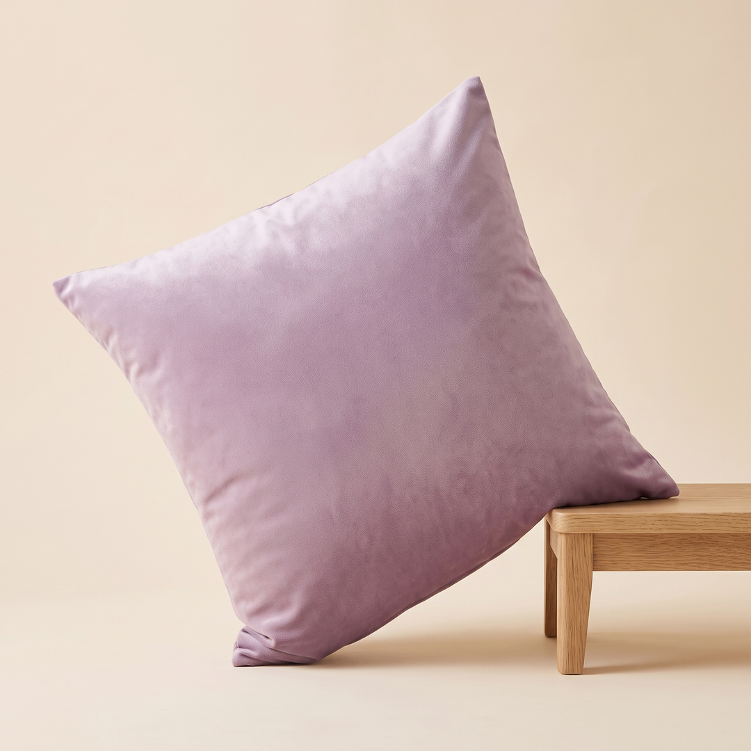 Velvet Pillow Cover in Mauve – tilted with one side propped on a stool edge