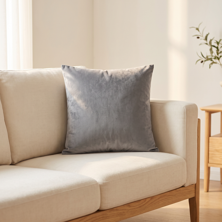 Velvet Pillow Cover in Gray – propped on a cream linen sofa with oak frame in sunlight