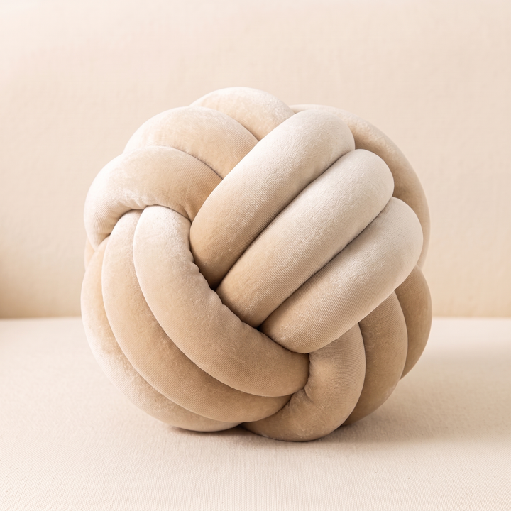 Velvet Knot Pillow in Cream – slightly raised angle showing the interlocking rolled strands