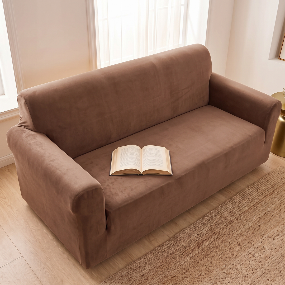 Velvet Stretch Sofa Cover in Chocolate Brown – from above with an open book on the seat