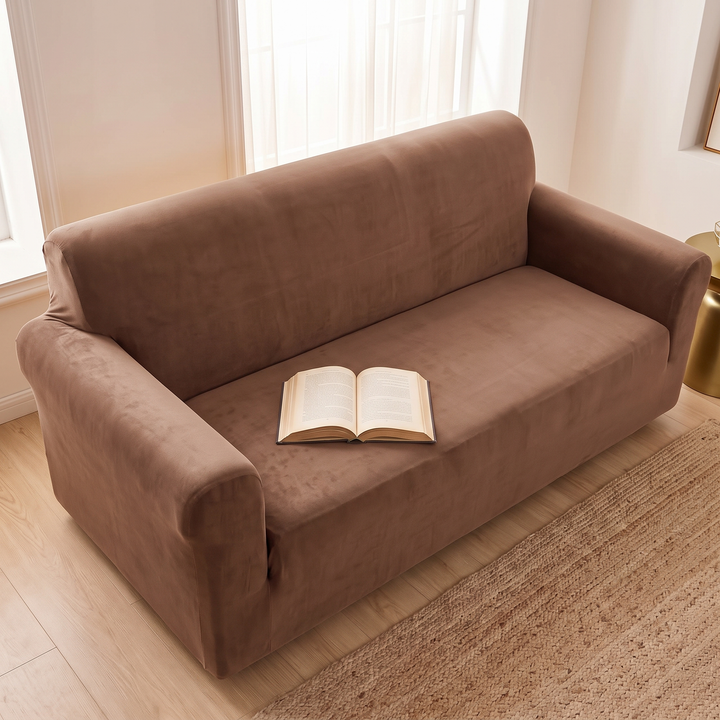 Velvet Stretch Sofa Cover in Chocolate Brown – from above with an open book on the seat