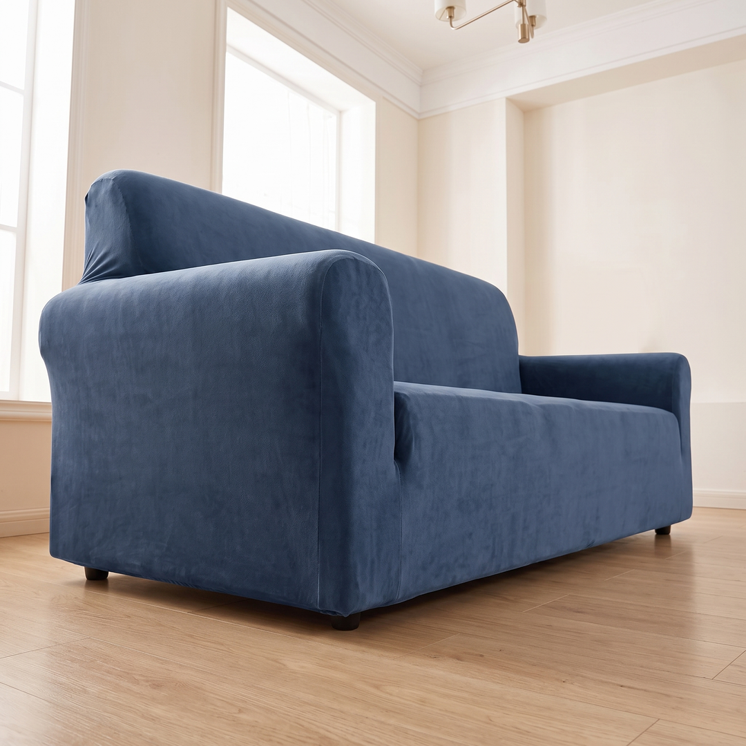 Velvet Stretch Sofa Cover in Navy Blue – low angle view in an empty room with tall windows