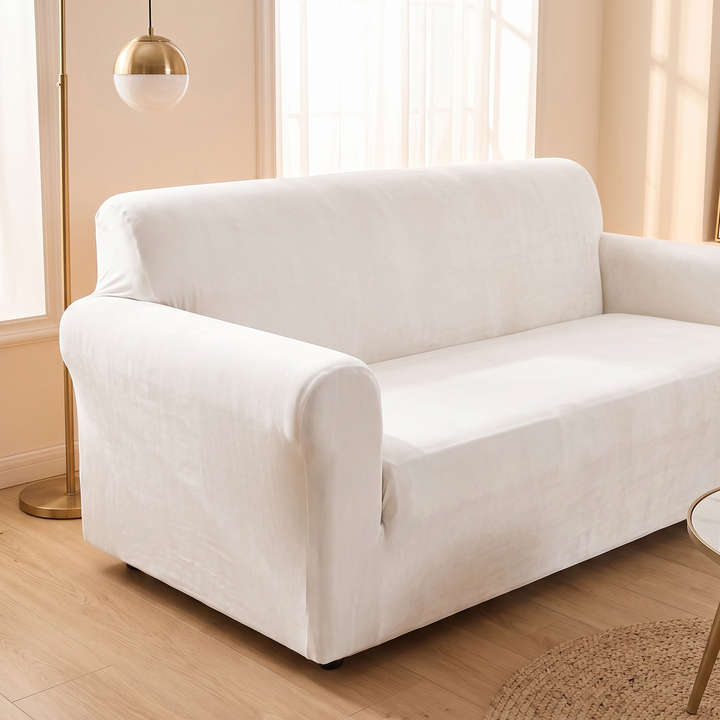 Velvet Stretch Sofa Cover in White – sofa beside a brass floor lamp and sunlit window