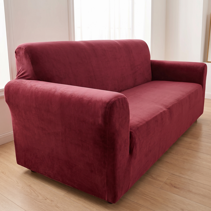 Velvet Stretch Sofa Cover in Burgundy – front corner view with near armrest large in foreground