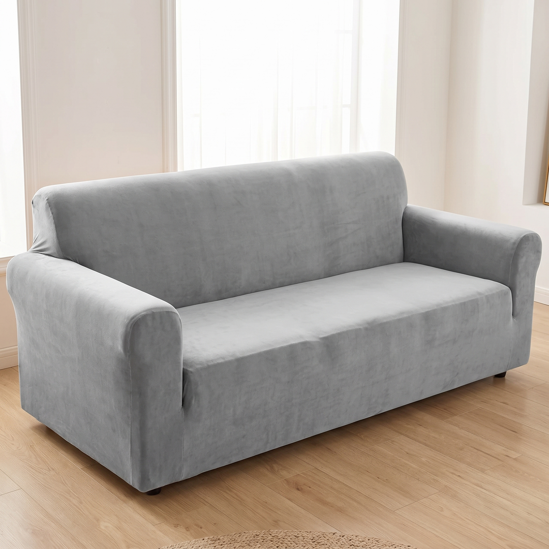Velvet Stretch Sofa Cover in Gray – fitted on a three-seat sofa in a bright living room