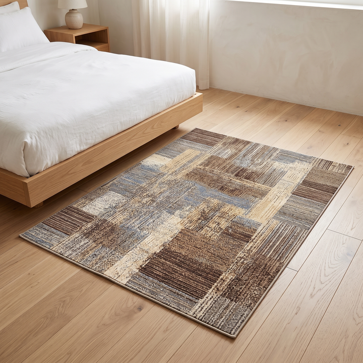 Vintage Patchwork Rug – Washable in Brown – on a wood floor beside a low platform bed