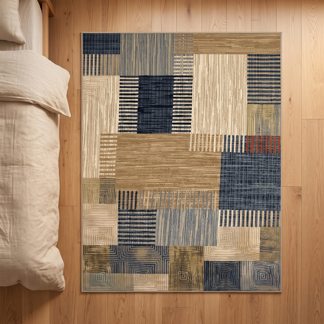 Vintage Patchwork Rug – Washable in Tan &amp; Navy – top-down view of the whole rug next to rumpled bedding