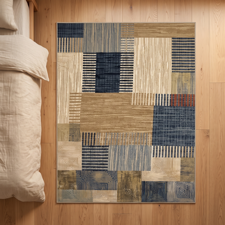 Vintage Patchwork Rug – Washable in Tan &amp; Navy – top-down view of the whole rug next to rumpled bedding