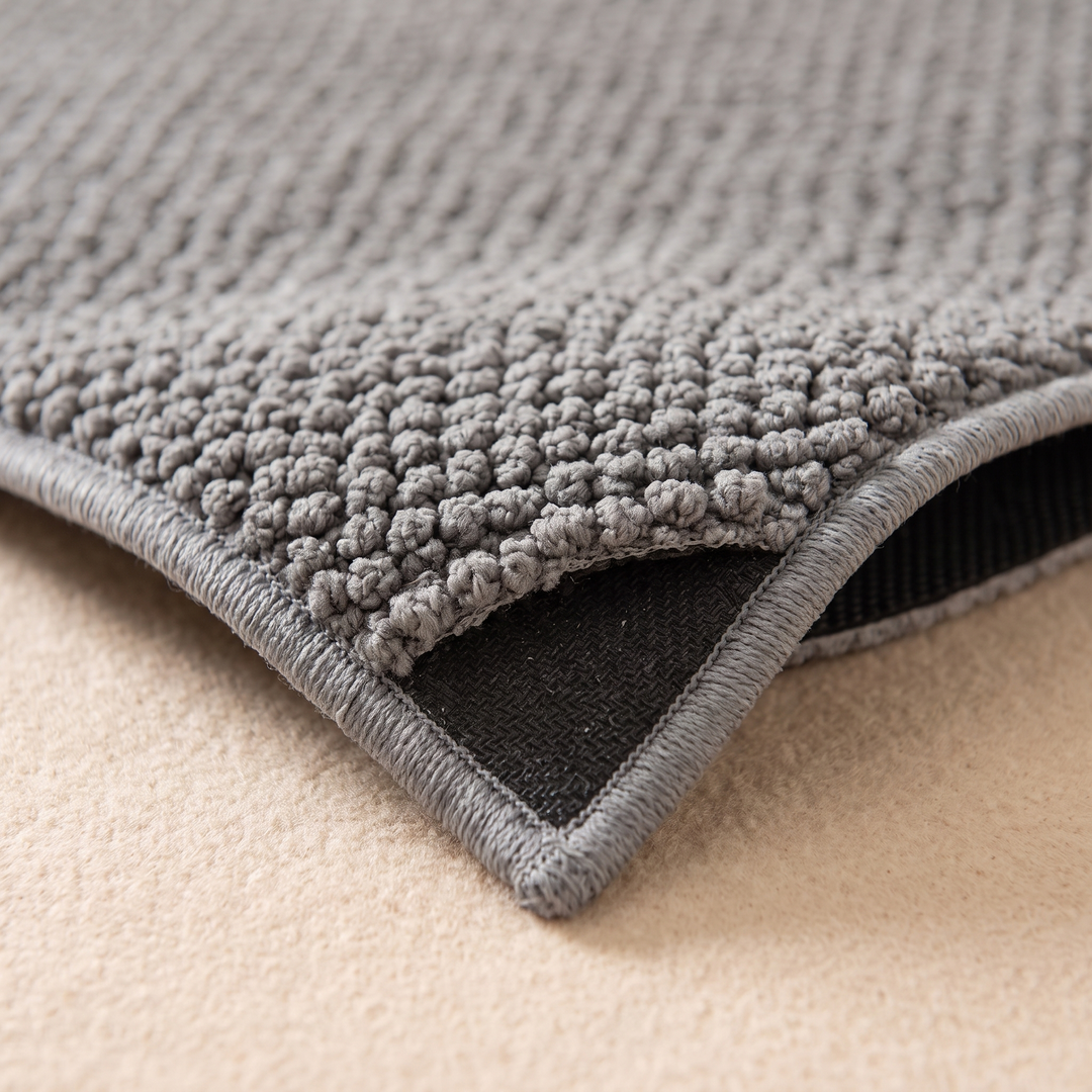 Indoor Door Mat – Washable, Non-Slip in Gray – close-up of a lifted corner showing the black backing and stitched edge